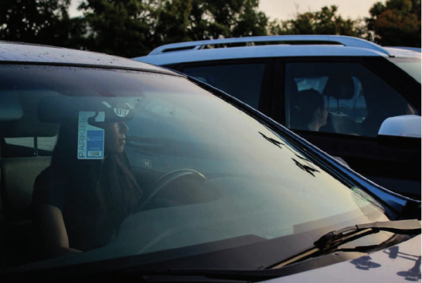 Full-week parking: Senior Lauren Wu sits at the wheel of her car inside the school parking lot and is grateful for the return of the five-day-a-week parking privilege. Some students from the Class of 2024 faced transportation issues with the previous four-day-a-week parking policy, such as Wu’s past tennis teammates.